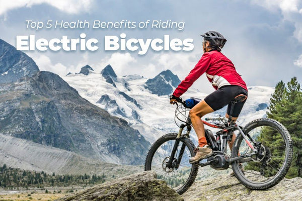 Man on bicycle with view of snowy mountains in background