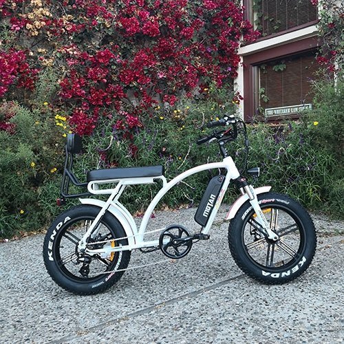 AddMotor 750W Motan M-60 R7 Comfort Fat Tire white bicycle parked next to plants